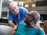 A medical provider checking in with a patient.