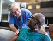 A medical provider checking in with a patient.